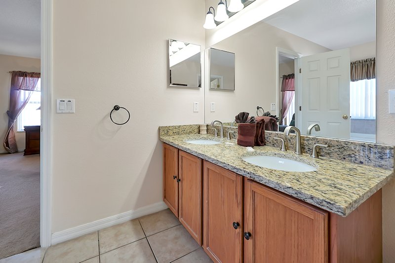 Master bathroom with twin sinks and very large walking wardr